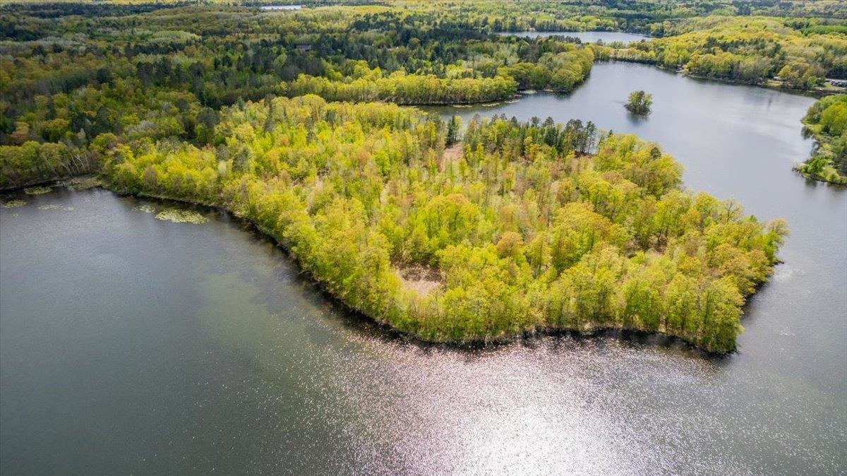 Welcome to one of the most extraordinary properties in Northern Wisconsin. A rare peninsula property offering nearly 360° of lakefrontage—privacy, panoramic views, and endless waterfront access. Perfect for a family retreat or legacy estate in the heart of Northern Wisconsin’s natural beauty. Private peninsula, this 21.56-acre retreat offers an unprecedented 2,850 feet of shoreline on the pristine, spring-fed Half Moon Lake—an exclusive 106-acre lake just two minutes from the quaint town of Iron River. This parcel is more than land—it’s a legacy property. Tucked away from view and surrounded by nature, this secluded parcel provides the perfect canvas for your family’s dream estate. With multiple open clearings visible in aerial footage, the land offers incredible potential for a family where various residences are built while preserving privacy and togetherness. Whether you envision a primary lakeside residence, guest cabins, or multi-generational homes, this rare offering delivers unmatched tranquility, natural beauty, and development potential. This exceptional property is just minutes from countless recreational opportunities—perfect for anyone looking to embrace the four-season lifestyle the Northwoods is famous for. For outdoor enthusiasts, nature, adventure, and relaxation come together in one incredible Northern Wisconsin location. There will never be another like this property in Northern Wisconsin. It is a once-in-a-lifetime opportunity on Half Moon Lake, 21.56 acres with 2,850 feet of waterfrontage in Bayfield County.