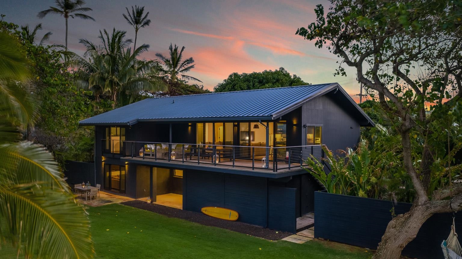 Located in the timeless beachfront community of Paia sits a modern, stylish private beach home.  Poised on a lush grassy knoll with 170 feet of sandy beachfront, enter through a private gate to this .67 of an acre compound.  Once inside, your world shifts and slows down, as the transition to beach life begins.  The first home is a classic iconic over 1,000sf cottage built-in 1910.  The main home is modern, and a comfortable 4,300sf beach home with all amenities.  Sleep in while you gaze from your bedroom across your compound to the turquoise blue ocean.  Enjoy an easy 3 mile stroll of beach walks right from your front door.  The entire compound is well set up for indoor-outdoor living amenities.  The covered lanai has sweeping Pacific Ocean views and is complemented by modern and cozy living areas, including a chef-style kitchen, clean white marble bathrooms and 3 car garage.  Extra space is intelligently designed into multiple areas offering plenty of opportunities for weekend gatherings, ohana, beach time, and beautiful sunsets.  Walk into town for over 13 restaurants, mana foods, and 30 boutiques.  This is a rare opportunity to be right in the heart of Paia and on a world-class white sand beach.  Beautifully furnished totally turnkey just bring your bathing suit and surfboard.  Owner interested in selling a 50 percent interest where both owners would have 6 months each.