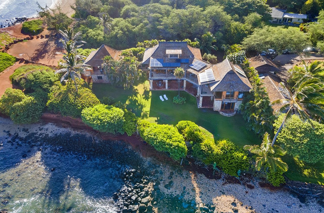 Iconic Maui oceanfront estate!! This North Shore Maui oceanfront oasis sits next to famous Baby Beach near the Maui Country Club. Surf the break right in front of the main house and enjoy magical sunrise to sunset ocean views from walls of glass and extraordinary lanais. This exquisite property seamlessly integrates chic contemporary elements and traditional Hawaiian architecture. Inspired by C. W. Dickey, constructed of hand-hewn coral, the dramatic living areas feature soaring ceilings opening to oceanside lanais. The ocean front main suite with lounging balcony encompasses the upper level. The lower level features a covered lanai and an additional 1500 square feet of flexible open space. The separate 1BR 1BA Ohana and 2 car garage complete this ocean front compound.