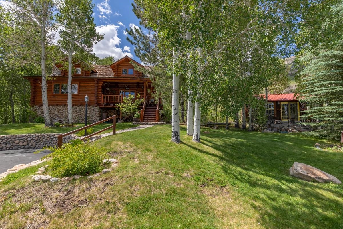 A home like this comes on the market once in a lifetime. This Log home was built with care and loads of attention to each small detail. Hand cut logs from Montana create a warm and cozy feeling throughout.  Located on 8.5 acres at the top of the Aspen Springs Ranch neighborhood, the views are unlimited from your front porch!  Enjoy cool breezes will taking in the views over the ranch community, meadows and all the way to Boundary Peak.  The property has a Main House, Guest House, and Workshop / Auto Barn.  Plenty of room for all your toys, and plenty of privacy.   Private well, year round stream, and mature Aspen Trees.  Zoned Equestrian, with a large level area for a pasture.