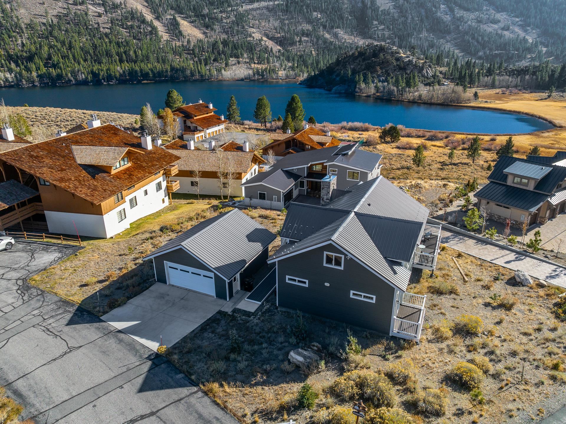 Located in the sought-after Highlands neighborhood of June Lake, this custom 2-bedroom + oversized loft home offers a perfect blend of comfort and scenic beauty. Enjoy amazing views of Gull Lake and the gorgeous surrounding mountains in this move-in ready home suitable for either full-time living or a vacation retreat.  Enter on the main level, where an abundance of natural light shines through large south-facing windows providing warmth in the living, dining, and kitchen areas. The open kitchen includes “butcher block” counter tops, a beautiful pebble backsplash and stainless appliances. The vaulted ceilings and a free-standing gas log fireplace enhance the open and inviting atmosphere, perfect for relaxation or entertaining. Also on the main level is the Primary Suite with a private deck and a gorgeous tile bath.  The second bedroom featuring bathroom access is also on this level along with convenient laundry closet. Both bathrooms and the entry boast heated floors for added comfort.    Upstairs you will find an oversized loft, offering ample sleeping space or convert this space to a game room, office, or additional living space. Smart thermostats, exterior cameras, and electronic lock entry enhance the home's modern convenience.  The large deck with fire pit is perfect to relax and enjoy the views after a day of outdoor fun.  A detached 2-car garage provides ample space for vehicles or outdoor gear. The location of this home is unbeatable, surrounded by outdoor recreational opportunities, including skiing at June Mountain, fishing in nearby lakes such as Gull, June, Silver, and Grant, and exploring numerous hiking trails. The prime position in the coveted June Lake Highlands ensures both breathtaking natural surroundings and easy access to local amenities, shops, and restaurants. Mammoth Lakes, just 20 minutes away, adds an extra layer of convenience.  This furnished home is move-in ready making it available to enjoy now.  Nightly rentals are not allowed.
