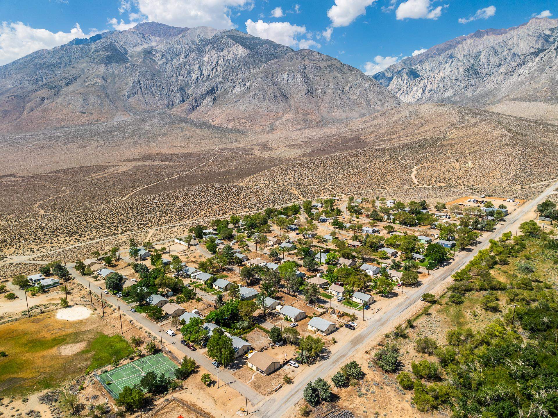 Discover Pine Creek Village, a prime real estate investment located at the base of the Sierra Nevada Mountains near Bishop, CA. This expansive 30-acre parcel includes 85 rental homes. The community features 64 three-bedroom, one-bath homes and 21 two-bedroom, one-bath homes , averaging 1,029 square feet each. Recent upgrades include new roofs, double-pane windows, Internet, plank flooring, and modernized kitchens and bathrooms. The property offers a community water system, a wastewater treatment facility, and a 2,400 square foot maintenance.  Potential subdivision would provide for existing homes on lots averaging 10,000 square feet.  Located just 15 miles from Bishop, CA, and 35 miles from Mammoth Lakes, CA where nationally recognized Mammoth Mountain ski resort is located, this property serves the vibrant communities of Bishop, Mammoth Lakes, and beyond. The Eastern Sierra region, renowned for its outdoor recreational opportunities, is a desirable destination for both residents and tourists. With a median home price of approximately $500,000 in the Bishop area, Pine Creek Village offers an exceptional investment opportunity at just over $175,000 per home. Established in 1947, this historical site originally served as housing for Pine Creek Mine workers, and it continues to offer significant value and potential.