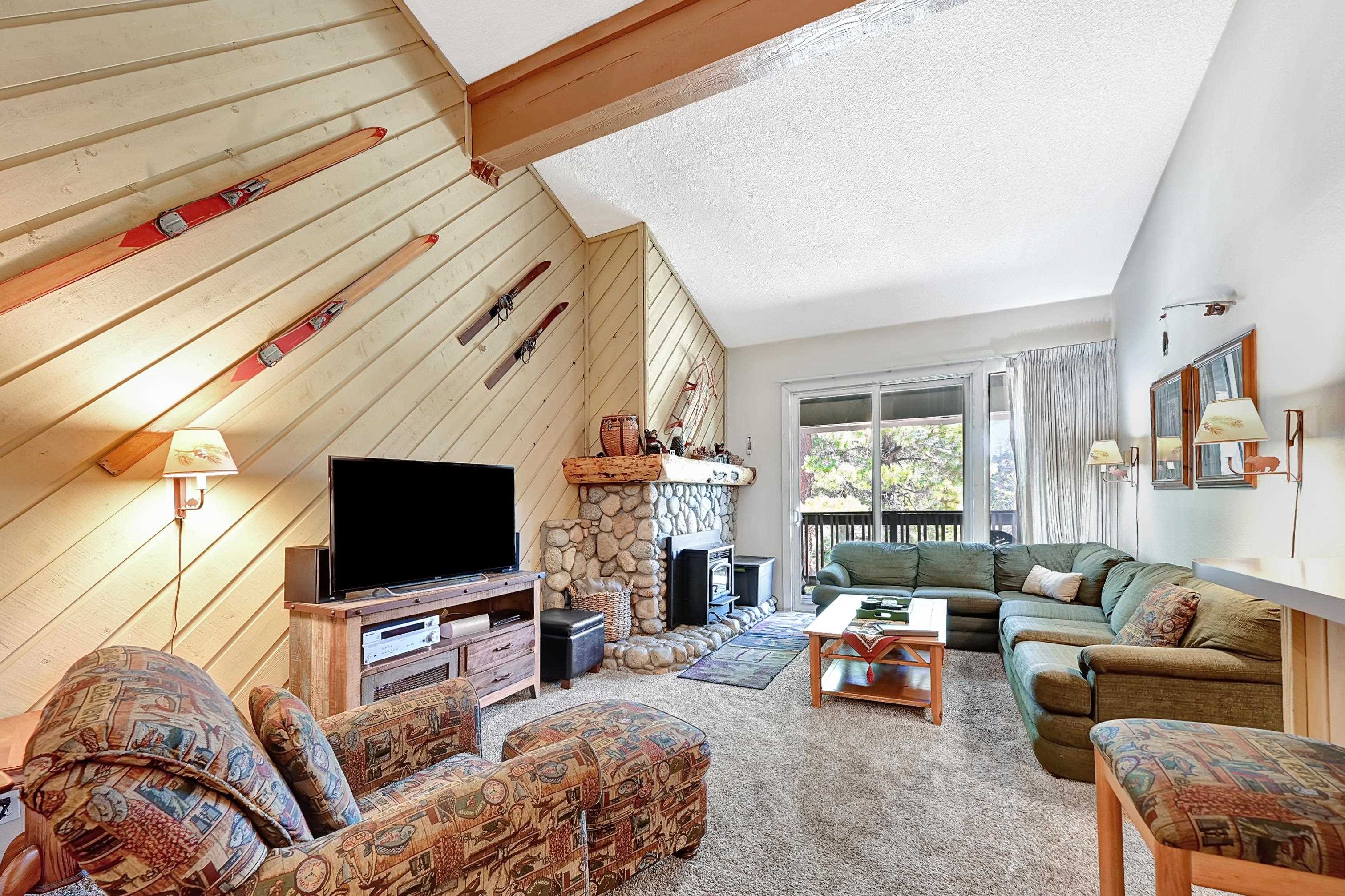1 Bed + LOFT - Close to Mammoth Village! - This well maintained, turn-key top-floor condo offers a versatile and spacious layout with a primary bedroom, an ample sleeping loft, and three refreshed bathrooms—two downstairs and one upstairs—perfect for accommodating larger groups. This unit can sleep 4 adults and 2 children with ease. Highlights include a charming river rock fireplace, a code-compliant pellet stove, upgraded dual pane sliding glass door, and scenic northerly mountain views through the forest. The unique top-floor location ensures peace and quiet with no units above. Enjoy year-round comfort and convenience with underground parking (assigned space + guest parking), an owner’s ski locker, common area laundry, spa, recreation room, onsite management, and a shuttle bus stop right in front of the complex. This condo is known for having some of the lowest HOA dues in Mammoth, which include exceptional snow removal services. Cable and internet are only $51/month. With a 10-year Airbnb history and a 4.9-star rating, this unit offers strong rental potential. Sold fully furnished—move in and start enjoying everything Mammoth has to offer!