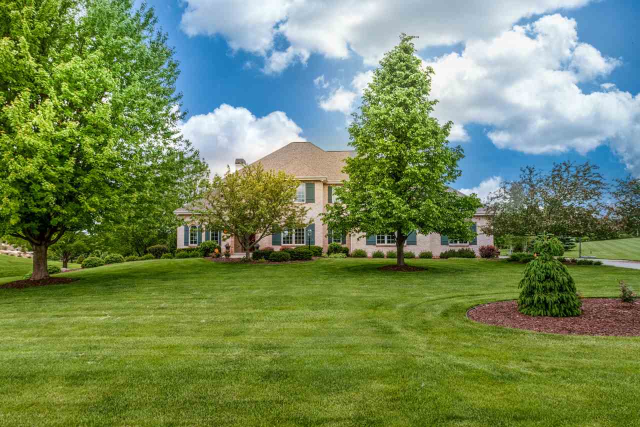 This stately brick faced home on over 1.5 acres in Pheasant Point exudes European elegance. A double arched entry door, sunny office w/floor-to-ceiling bookshelves & french doors w/transom, a gorgeous open staircase w/wrought iron balusters, a stunning great room with a wall of windows that flood the space w/natural light and highlight architectural details like the arched built-ins flanking the  gas fireplace with its graceful mantel. The open kitchen + dinette, refined in its design, has all the modern luxuries you want in a kitchen. You'll also love the exposed finished lower level rec room w/fireplace, large studio/exercise rm, office & bedroom. The upper level bedrooms include a tranquil owner's suite + 2 other large bedrooms with fantastic built-ins. So much to love!