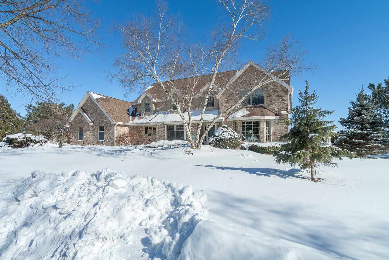 A beautifully updated home situated at the end of a cul-de-sac w/sweeping, elevated views of the park. Defined by it's natural surroundings, the synergy between the inside & outside of this home is evident in all seasons. In the warm months, the outdoor calls whether that means relaxing on one of the decks or hiking on Elver Park trails. Views can be enjoyed year round from the spectacular sunroom, 2-story great room w/statement fireplace + wet bar—ideal for entertaining—& from the bedrooms. The remodeled, eat-in kitchen, next to the formal DR, incl. gorgeous granite counters & an island w/seating. The inviting LR leads to a study w/french doors. The w-out LL rec room enjoys access to the private yard, as well as a lovely stone fireplace. Main floor laundry. Middleton Schools.