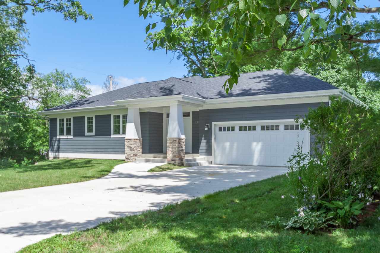 Gorgeous brand new home in an established west side neighborhood w/mature, wooded lots! This open plan, sunny home is a delight to spend time in as it exudes quiet serenity. The modern kitchen w/white shaker cabinets, easy-care quartz countertops, a gas cooktop, + a large island w/seating opens to the dining area & great room w/gas fireplace. Glass sliding doors to the deck flood the space w/natural light & verdant views of the trees. Beautiful hardwood floors add warmth. The master suite offers a luxurious place of respite w/high ceilings, a big WIC + a bathroom w/ a streamlined design w/peaceful, natural elements. 2 other bright bedrooms on the main level share a thoughtfully designed full bath. An unfinished, walkout LL w/sliding glass doors offers so much extra possible living space.