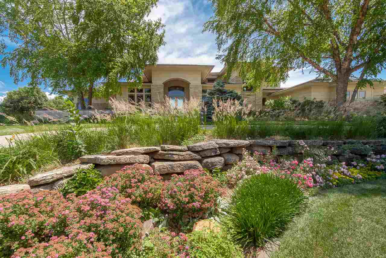 This stunning home in Carriage Ridge is a celebration of craftsmanship. Lush gardens bloom throughout the seasons on the gorgeous 1.3+ acre lot and offer sublime moments of peace as you meander the stone paths through the trees or listen to the quiet splash of the waterfall in the pond. The modern Prairie style of the exterior continues inside w/impeccable design details from the soaring ceilings, custom trim, thoughtfully designed built-in cabinetry, and stone hearth on the 2-way fireplace. With a floor plan that flows effortlessly, the entire main level connects to the natural beauty of its surroundings, from the sunroom & open kitchen with high-end appliances + luxe finishes, to the inviting living room, timeless dining room, and the serene primary suite. It's truly a work of art.
