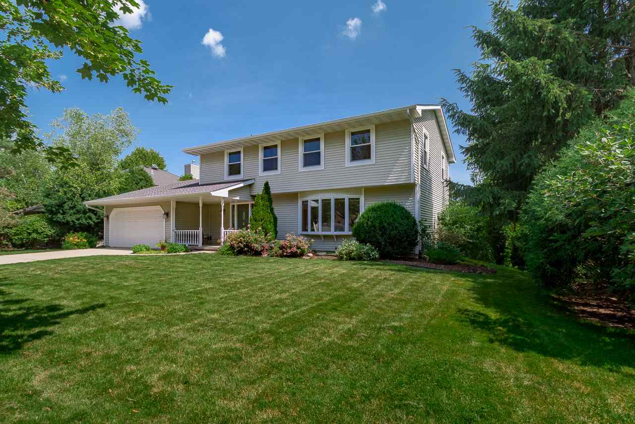 This beautiful Sauk Creek Colonial exudes serenity thanks to its light-filled interior and private outdoor spaces including a large deck that overlooks the private yard filled w/lovely gardens & a patio. A spacious foyer welcomes you into the home where you'll notice the gleaming wood floors that lead you into the sunny living room on the right, which in turn opens to the formal dining room. A few steps further and you're in the open space that includes the remodeled, Prairie-style kitchen with granite counters, pantry, + breakfast bar, the dinette, and the great room w/ a fireplace & doors to the deck. The large, finished LL is bathed in light from the glass patio doors and includes a bedroom & bonus room, perfect for an office or exercise room. Walk to parks, shops, dining & the library!