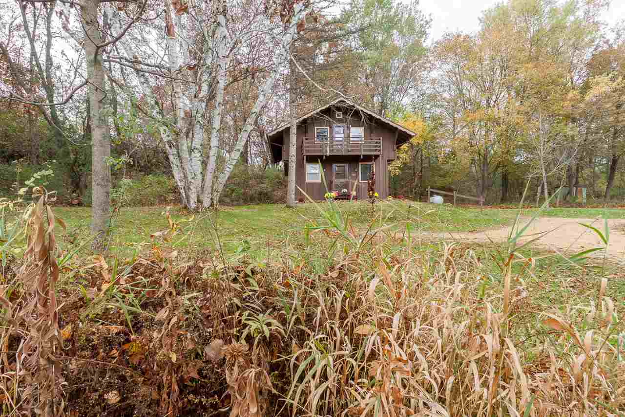 Looking for a country escape? A place to surround yourself with nature and still be close to all the city has to offer? It's your lucky day! This cozy home on almost 7.5 acres on the outskirts of Verona has been completely updated. Reminiscent of a Swiss chalet, the charm of this home cannot be denied. An open layout on the main floor includes the eat-in kitchen and living room, an office or bedroom, and a full bath. Upstairs, the main bedroom features a sitting area, bath with soaking tub, and a separate space that can be a second bedroom or closet. and there are not one, but two decks overlooking the gorgeous wooded lot. If you're looking for land to build your dream home, there's a perfect spot perched on the hill with beautiful views. Enjoy walking trails, wildlife and serenity.