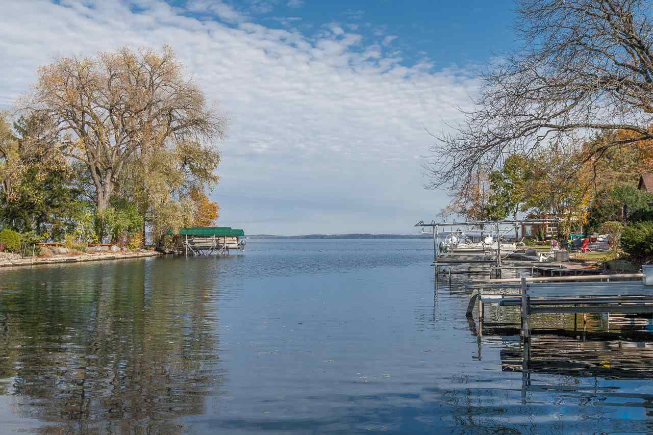 Welcome to the most charming cottage on Lake Mendota. Cherished by one family for 95 years, it's now your turn to create treasured memories in this sweet home.  With 75 feet of frontage complete with a dock + boat lift, it's an ideal weekend getaway, a cozy year-round cottage, or a prime spot to build the lake home of your dreams. Delightful details inside the home include cool vintage appliances—that still work!—original art deco light fixtures, an arched doorway, beautiful wood floors, the cutest bathroom you've ever seen, and, best of all, an expansive 3-season porch overlooking the water that you will never want to leave. Everything you need is on one floor— the spacious kitchen, sunny living/dining room, two bedrooms, a full bath, and a large storage closet. Lots of LL storage, too.