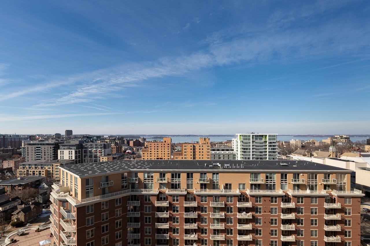 Enjoy sweeping views of Lake Mendota from this penthouse condo with two terraces. This is a rare opportunity to own a 1 bdrm condo w/such gorgeous city & lake views. The main floor features a gas burning fireplace, kitchen w/beautiful cherry cabinets + gas range, a wall of sliding doors to a terrace, a full bath & a walk-in storage closet. The serene lofted bedroom suite has a second gas fp, walk-in closet, + a full bath w/laundry. The unit includes a large, separate storage unit & parking space. Metropolitan Place amenities include onsite management, guest parking, fitness center, dog run & community terraces. The prime downtown location can't be beat—you're steps away from the Capitol, amazing restaurants and bars, theaters, music venues, parks, bike paths, coffee shops, and shopping.