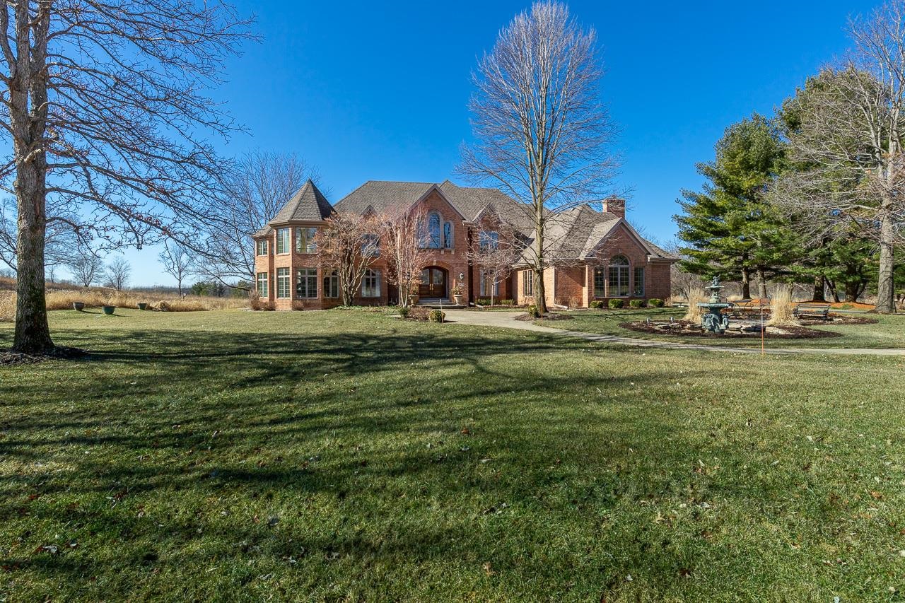 This stunning brick home on almost 2 acres overlooking a 20 acre conservancy is the epitome of luxurious elegance. A grand entry welcomes you in to this beautifully updated home. On the left is the living rm w/ 1 of 5 gas fireplaces. Next to that is the office w/gas fp + sunroom. More beautiful views are found in the great rm w/ 2-story high fp+ a wet bar w/wall of windows. Chef's will love the spectacular kitchen w/ Gaggenau stove, double ovens, walk-in pantry, and spacious island w/seating. The formal dining rm is just steps away thru the butler's pantry. A serene primary suite, and 3 ensuite bedroom all upstairs.  Entertain year-round in the awe-inspiring pool room w/wood ceilings, walls of windows, & a sitting area w/stone gas fireplace.  Finished LL, & so much more!