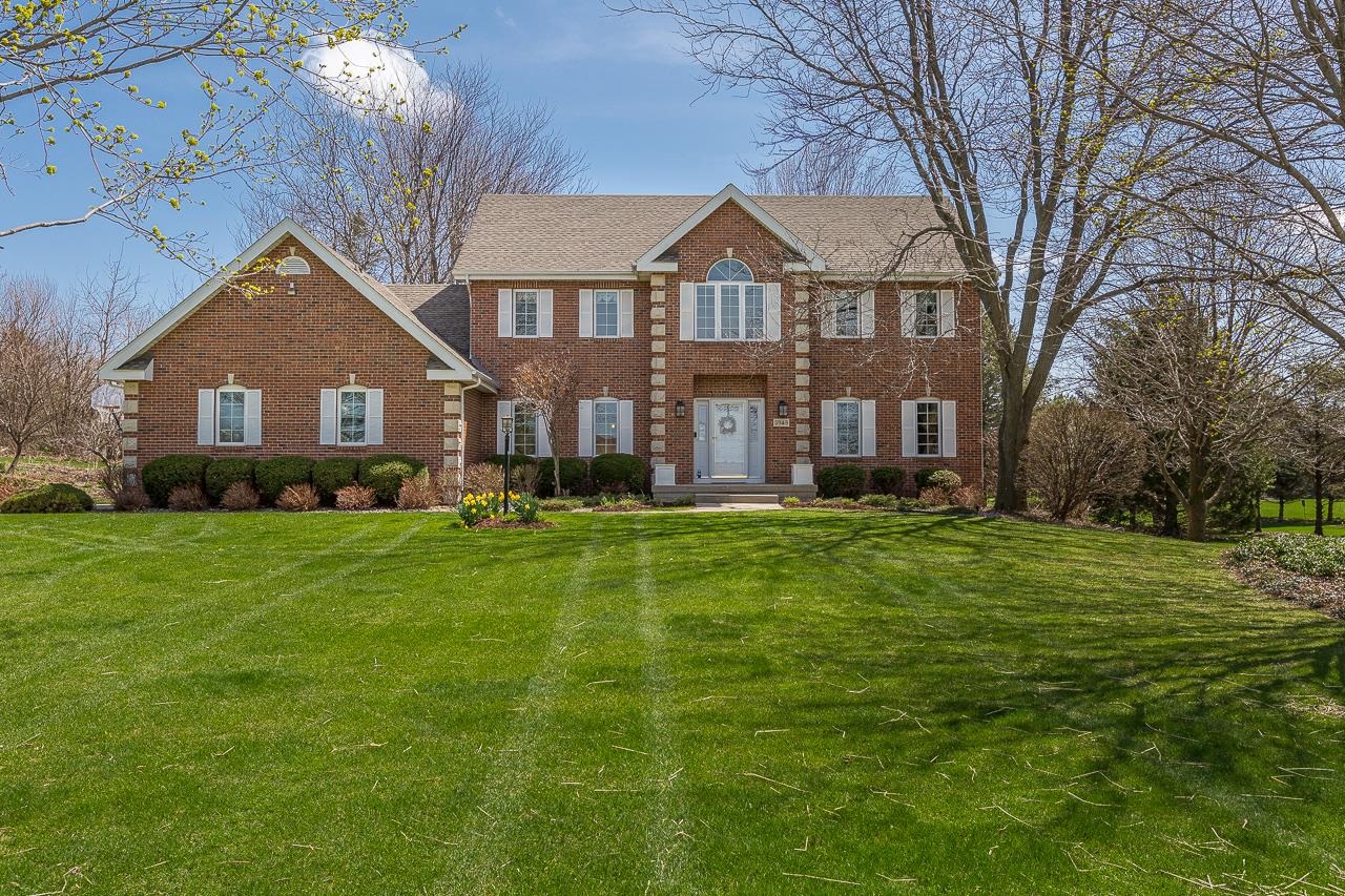 This stately brick front home on over an acre has beautiful custom details throughout that lend it personality and soul. Natural materials, bright, light-filled spaces, and an openness to the outdoors create a tranquil, sophisticated home. The ML exudes an inviting warmth, from the intimate den/office with exceptional custom built-ins, to the formal dining room, & the spectacular kitchen w/gorgeous cabinetry that opens to the great room w/fireplace & the serene screened porch. Even the mud/laundry room is beautiful! A finished LL offers extra living space with a large rec room and a guest space. The UL bdrms include the primary suite w/walk-in closet & thoughtfully designed bathroom w/a walk-in, tiled shower. Nearly every space has been updated.  A great place to call home!