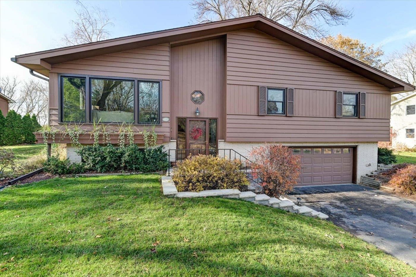 Showings 11/17. Beautiful home located close to Madison, in Oregon SD. Peaceful setting located on about 1/2 an acre w/ beautiful mature trees, well-cared for landscaping & privacy. Main level features vaulted ceilings, wood floors, large bay window letting in plenty of sunshine, & 4 season room. Porch walks out to a deck leading to a beautifully finished (new) stone patio out back overlooking the impressive yard. Main floor master w/full bath. Extra living space in the exposed basement. Sellers have done several updates to the home:replaced windows, new stove, newer dishwasher(4 yrs), new front concrete steps & patio('21),new furnace & AC('17), newer washer/dryer. Freshly painted walls throughout. Shed included, & invisible pet fence in place. Collars provided. Leaf guards on gutters.