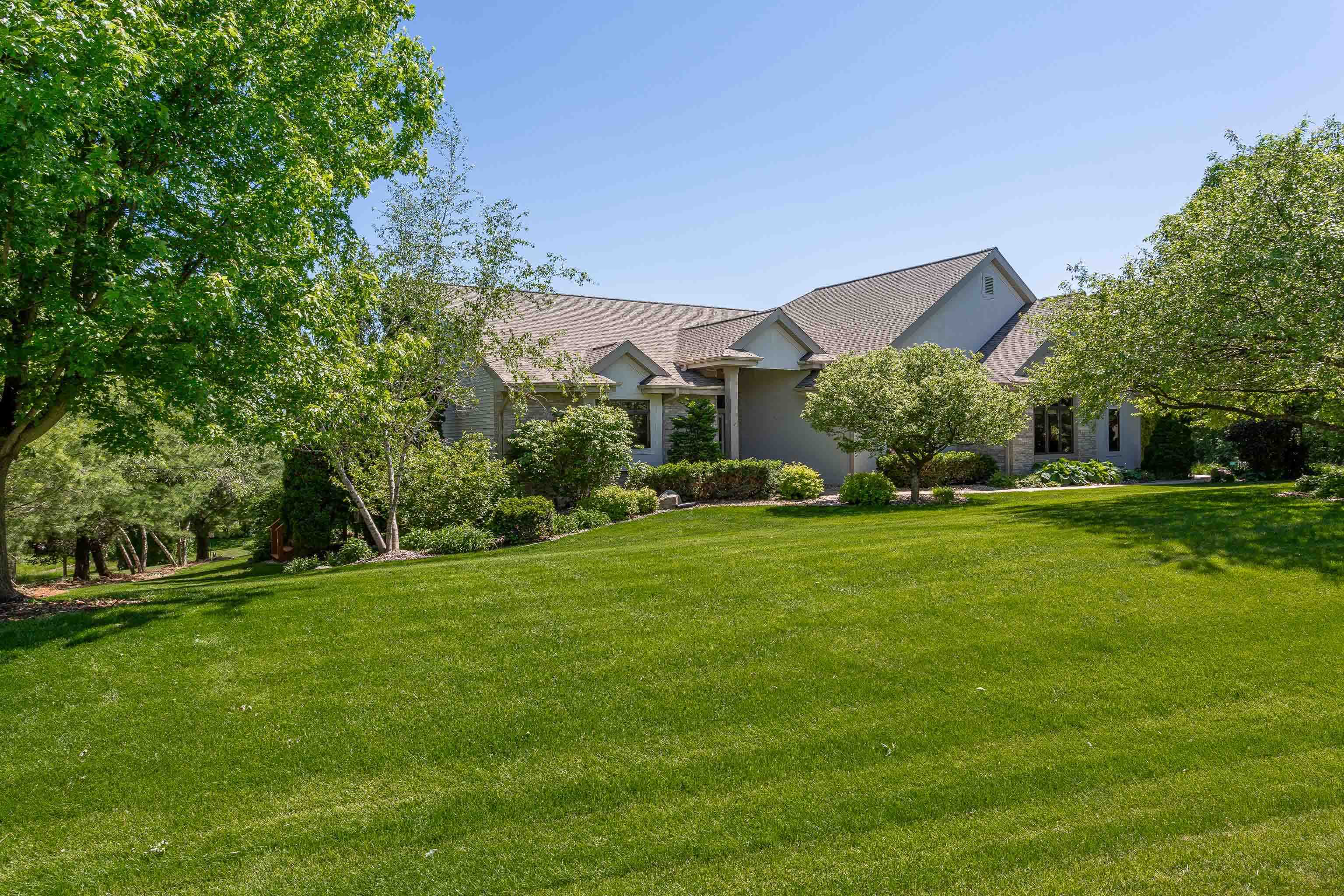 This luxe, private, eco-friendly home is simply stunning. Upon entry, you're greeted by an open space that feels like a modern treehouse w/walls of windows overlooking lush, verdant scenery. Whether relaxing by the fire in the great rm, enjoying quiet conversation in the sitting area, entertaining at the dining table, or whipping up a feast in the spectacular kitchen w/breakfast bar, endless counter space, + walk-in pantry, you'll delight in each moment spent here. An ode to serenity, the primary suite has a gorgeous bath w/steam shower, soaking tub & WIC. Outdoor spaces abound: screen porch, covered deck + a sunny deck off the primary suite & 2 patios on the LL. LL features a rec room w/ FP & kitchenette + 3 BRs & office. 2 yr old solar keeps this home extremely energy efficient!