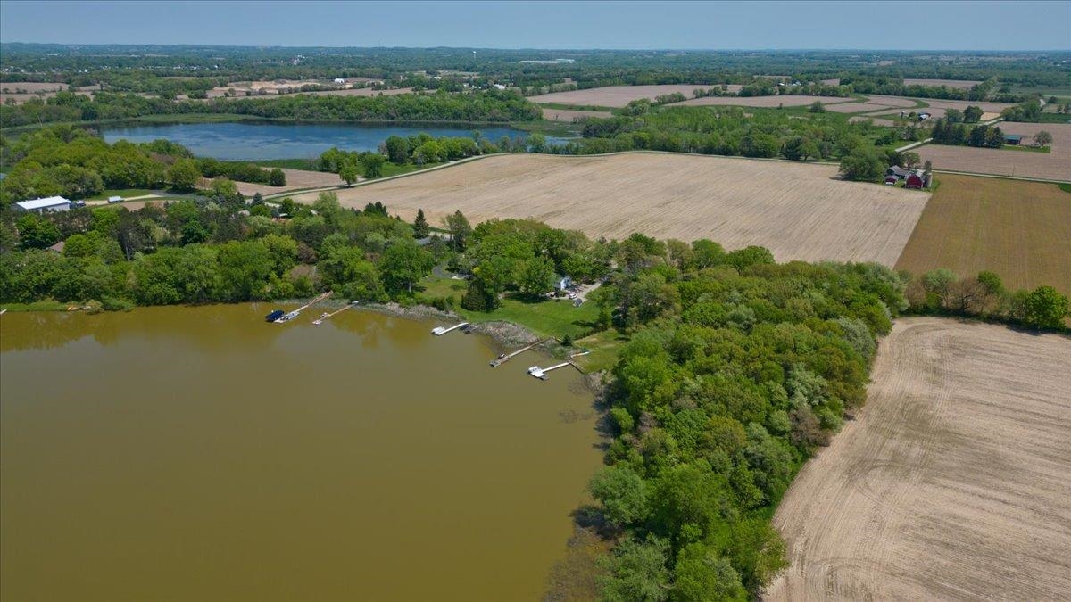 SOLD COMP Beautiful wooded lot on the edge of Bass Lake, just minutes from Stoughton. Come and build your dream home!