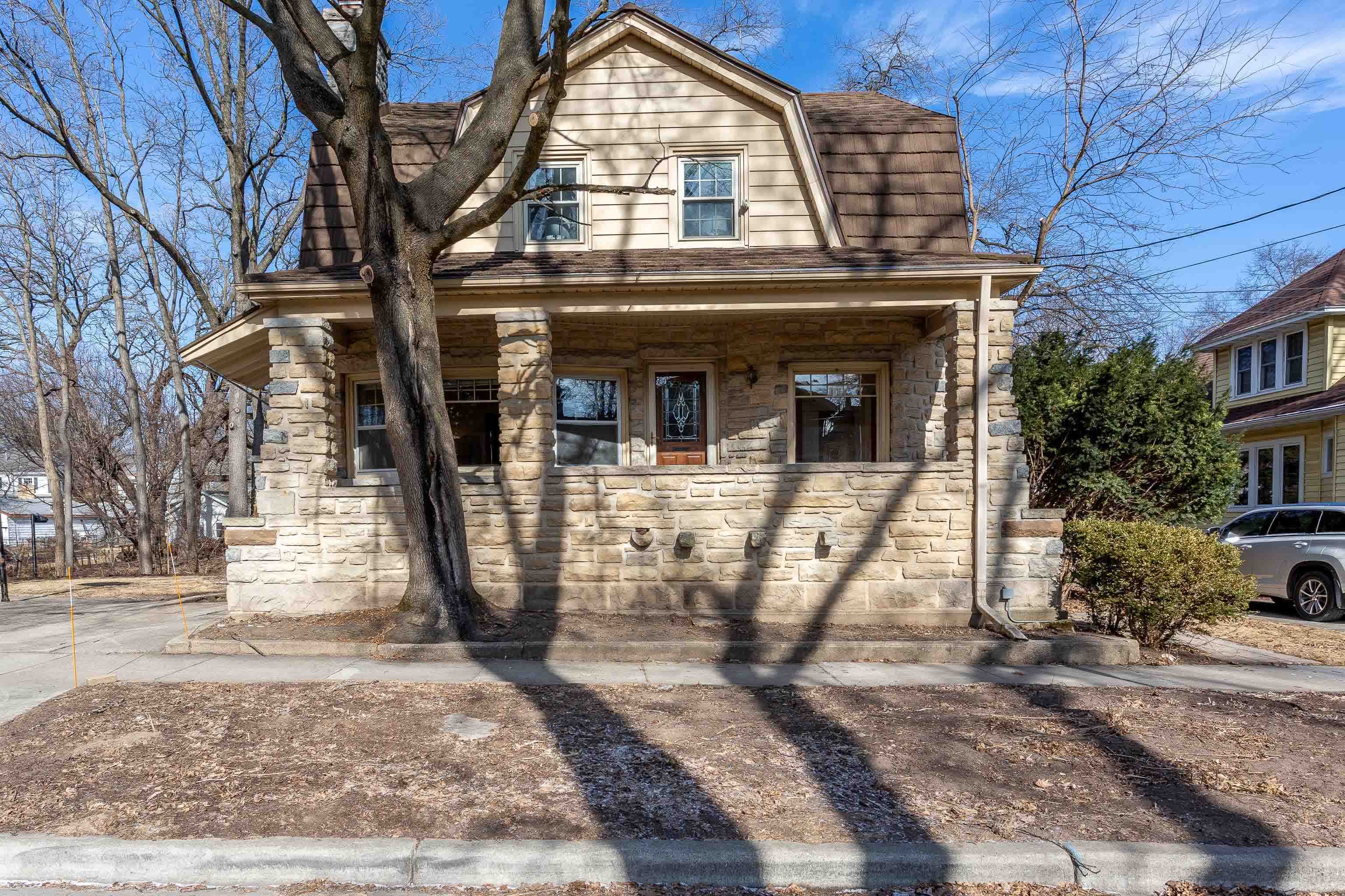 This stunning solid stone home offers timeless charm & modern convenience, featuring 4 to 5 bedrooms on a large, beautifully landscaped mature lot that backs up to a scenic bike trail. The home's character shines through with its gorgeous woodwork & spacious rooms, creating a warm, inviting atmosphere. Located in a highly walkable near west neighborhood  just steps away from shopping, parks, restaurants, & the excitement of UW Badger games. With a one-car garage & plenty of outdoor space, this home is perfect for anyone looking for a blend of elegance, comfort, & accessibility. The kitchen is waiting for you to put your own touches on to make this home exceptional. Roof replaced with 50 yr steel & stone shingles 2015 w/heated gutters. Many windows replaced since 2000.