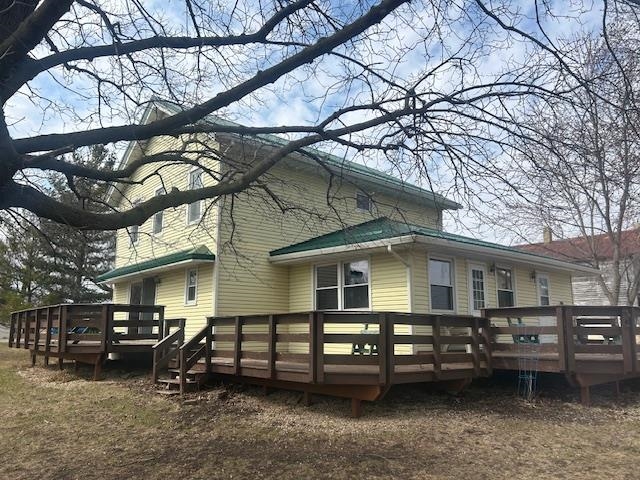 Hillside Hobby Farm sits on 5.6 acres. Main level bedroom, family room & mudroom/laundry.  The large living room has 8 foot wide patio doors that lead to 3-tier wraparound deck. Large eat-in kitchen has double windows over the sink & a large pantry w/custom-built shelving. Spacious master bedroom upstairs. Two walk-in closets. Detached garage is 4-car size & has a concrete floor, roll up back door & wood burning stove. Outbuildings include garage w/second story loft, chicken barn & barn. Newer conventional septic drain field (est 6 years). Metal roof, aluminum siding, soffits & vinyl windows are also updated. The property has fruit trees and raspberries to enjoy. 4 goats and about 16 chickens are optional. Country living close to town.