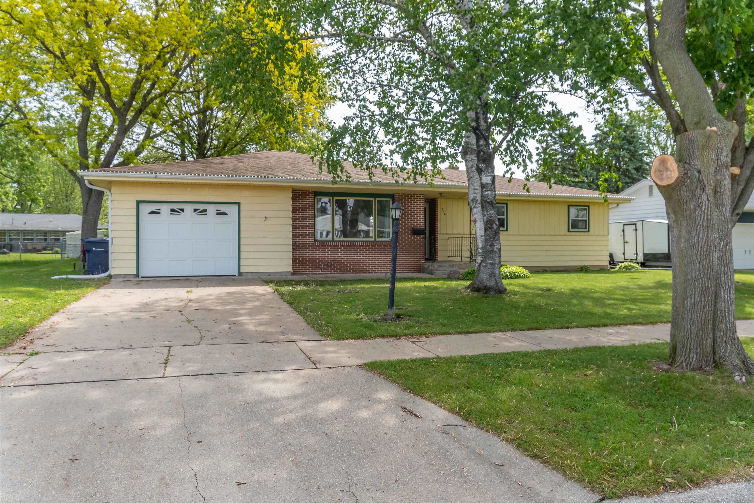 Spacious Ranch home in wonderful neighborhood. 3 bedroom, 2 bathrooms plus a large 3-Season sunroom. There is room for everyone here with a 1/4 acre fully fenced lot! Convenient floor plan offers a main level family room as well as a main level living room! Patio door to east-facing sunroom & backyard for wonderful morning sun. Spacious kitchen with all appliances included. Nice breakfast bar area and big pantry as well. LVP flooring and real hardwood floors throughout the main level. King size primary bedroom.  Dry poured concrete basement will give you lots of future extra square footage. Seller was in the middle of finishing the LL before this move came up. Retro bar in the basement is included. New Central Air unit, furnace and new roof in 2017.