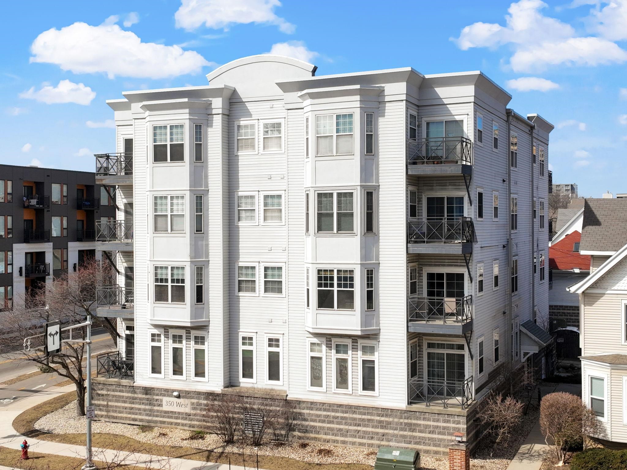 Bright and spacious elevated corner unit with no shared walls and soaring ceilings in a prime downtown location. The thoughtfully updated kitchen features quartz countertops, stainless steel appliances, an artistic backsplash, gas range, and breakfast bar. The open layout includes a sunny living area with a cozy office nook, plus a rare half bath for guests. The large primary suite offers tall windows, a walk-in closet, and a full bath with separate tub and shower. Enjoy in-unit laundry, a private patio, deeded garage parking, and same-floor climate-controlled storage. Just steps from Lake Monona, Brittingham Dog Park, and all downtown Madison has to offer.