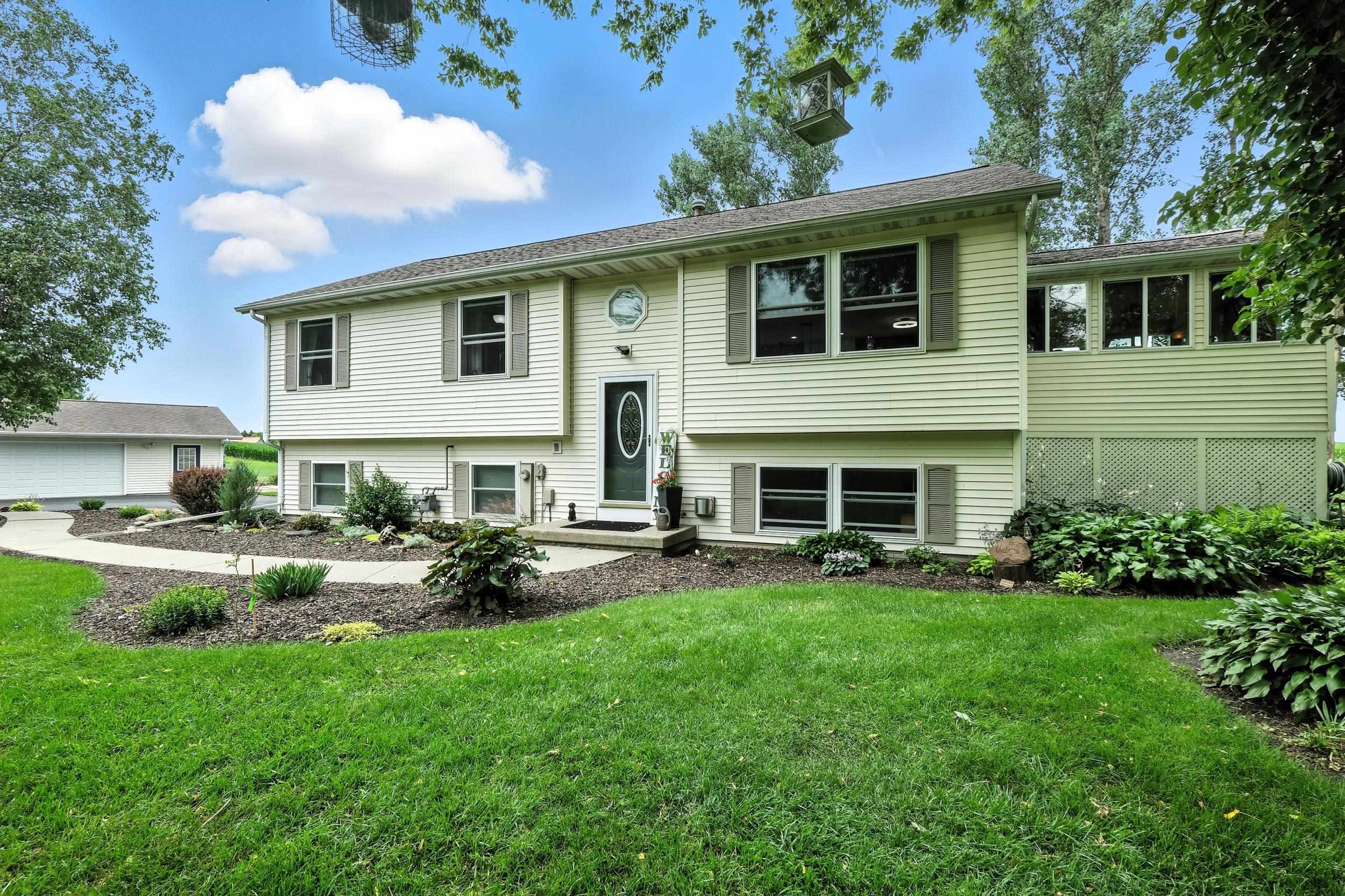Beautifully maintained home on 1.23 Acres and a quiet Cul-de-Sac! Charming 4BR/3BA home, stunning views, what a peaceful rural setting! Remodeled, open layout AMAZING kitchen (2020) w/quartz counters, center island, black SS appliances (7yrs), gas stove, pantry, & under-cab lighting. Cathedral ceilings in E-facing 4-season room w/gas stove leading to deck. Spacious living room, updated lighting & flooring (2020), & freshly painted. Primary suite features heated floors, large king sized room & oversized soaker tub. LL includes dry basement, with 4th BR w/ensuite ½ BA, family room w/efficient gas FP, & barn door for privacy. Attached 26x24 heated garage + detached 4 car sized (36x26) heated/insulated garage w/40A subpanel (furnace new 2020). Backs up to field. Come, relax in the country!