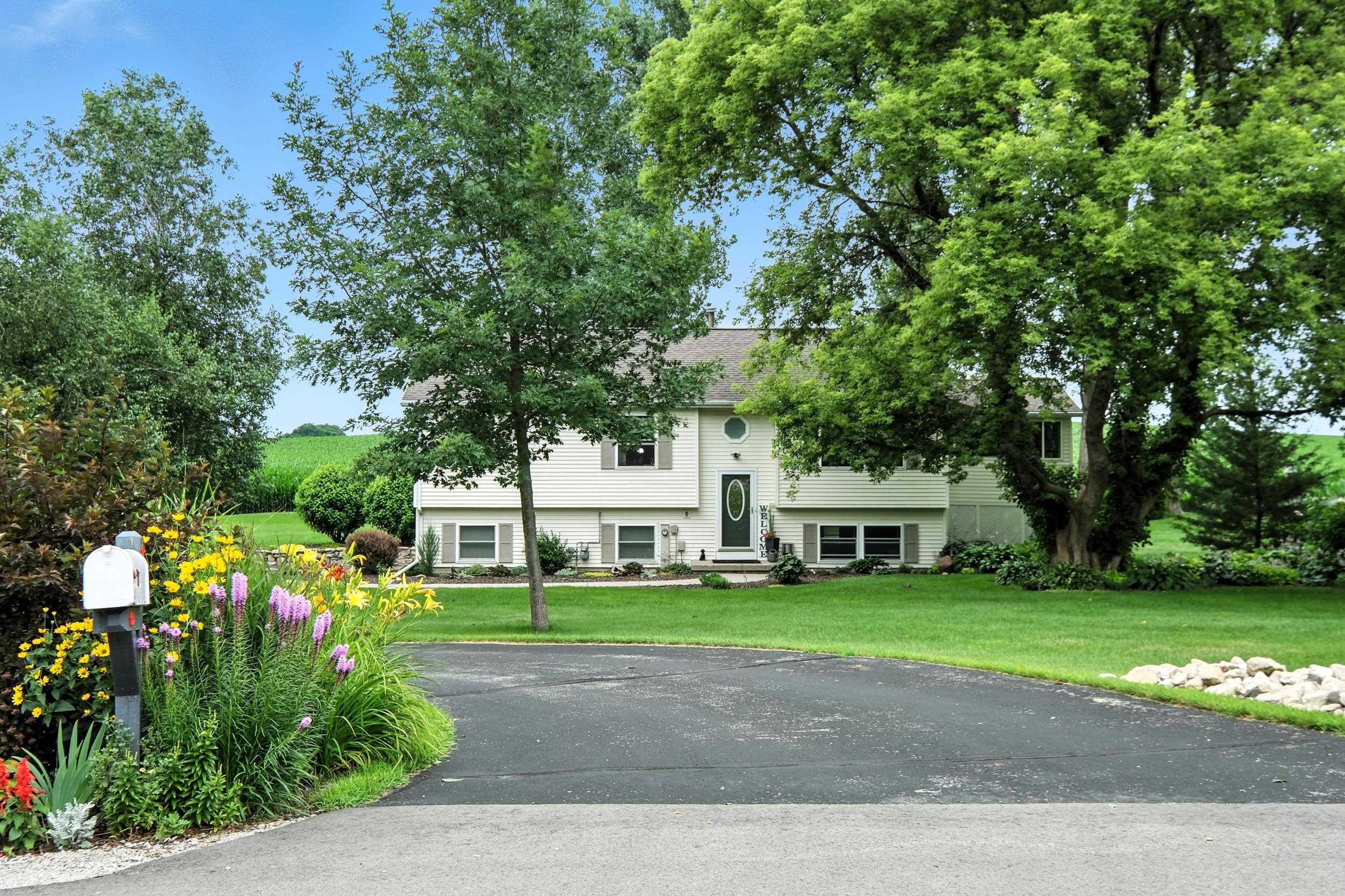 Beautifully maintained home on 1.23 Acres and a quiet Cul-de-Sac! Charming 4BR/3BA home, stunning views, what a peaceful rural setting! Remodeled, open layout AMAZING kitchen (2020) w/quartz counters, center island, black SS appliances (7yrs), gas stove, pantry, & under-cab lighting. Cathedral ceilings in E-facing 4-season room w/gas stove leading to deck. Spacious living room, updated lighting & flooring (2020), & freshly painted. Primary suite features heated floors, large king sized room & oversized soaker tub. LL includes dry basement, with 4th BR w/ensuite ½ BA, family room w/efficient gas FP, & barn door for privacy. Attached 26x24 heated garage + detached 4 car sized (36x26) heated/insulated garage w/40A subpanel (furnace new 2020). Backs up to field. Come, relax in the country!