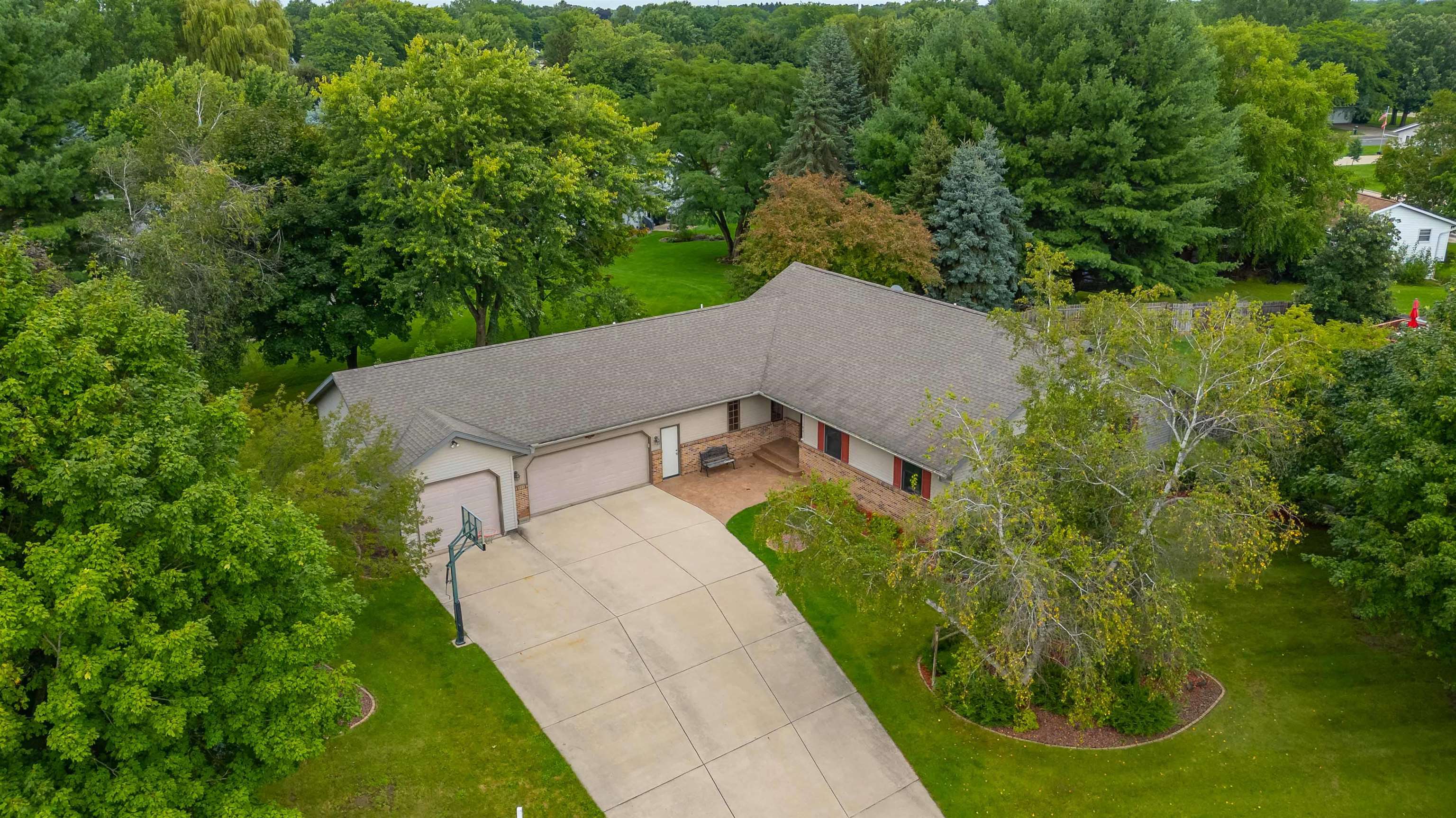 Rare oversized RANCH w/ 3,393 fin sqft on .39-acre lot in quiet Columbus neighborhood! Vaulted ceilings. Kitchen cherry cabs, granite, SS apps, brkfst bar, pantry w/rollouts. Flex DR/office, main level remodeled laundry (’22), king-sized primary suite, updated baths, & LVP flrs (’21). LL features huge FR, gas Fireplace, wet bar, 4th Bedrm, full bath w/heated floor, & tons of storage. 4 car tandem garage w/X tall door & basement access. Maint-free deck, covered front porch, extra pad for boat/trailer. Insulated foundation. Solid wood doors, radon system. Hot tub included! Bow window, inlaid real wood floors, wide halls, tons of natural light—move-in ready! Great layout, quiet street, close to schools, parks, & quick access to Hwy 151 for commuters. Great yard! Truly a one-of-a-kind home!