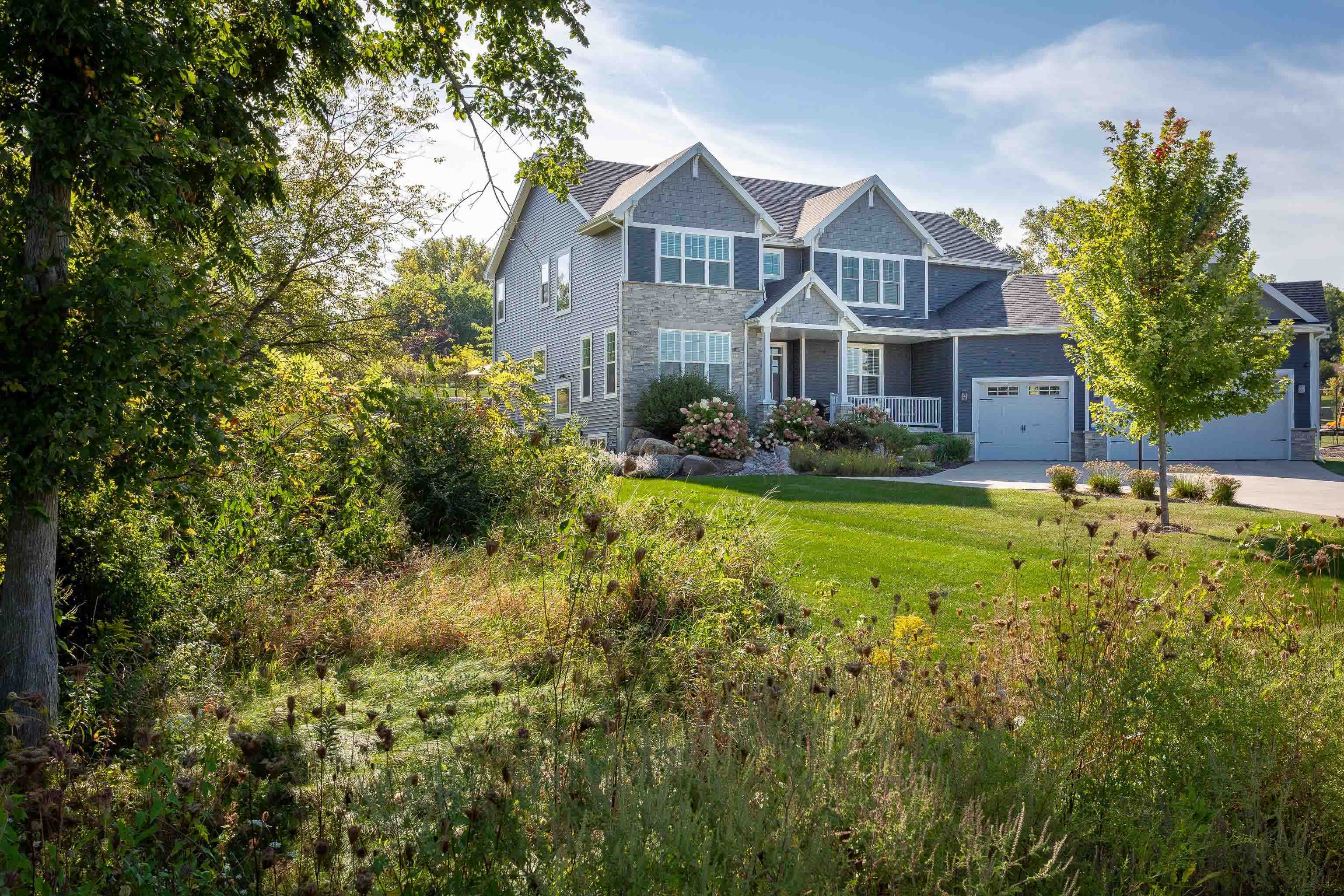 Built in 2018 and set on nearly an acre, this stunning home blends modern elegance with everyday comfort. The sun-filled main level features a gourmet kitchen with an oversized quartzite island, sleek finishes, & an open flow to a formal dining room + two living spaces anchored by gas fireplaces. Expansive windows frame lush views, leading to a deck and patio with firepit - perfect for entertaining. The main level includes an office & laundry room. The primary suite offers a spa-like bath + walk-in closet, while 4 additional ensuite bedrooms provide room for all. A spacious finished lower level extends the living space with endless possibilities. With .87 acres of landscaped beauty & serene privacy, this is the perfect retreat to call home. Walk to parks & Sunset Ridge Elementary.