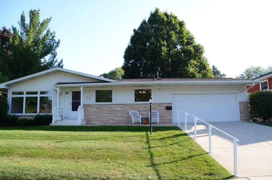 Delightful 3-bedroom ranch in mint condition! Just move in & enjoy! Perfectly located near East Towne, restaurants, parks, & schools. Bright & inviting living room open to the DR - ideal for entertaining & everyday life. The spacious kitchen offers abundant cabinets, solid-surface countertops, large sunny window & dinette. Cozy up in the family room featuring a fireplace with beautiful built -ins, patio door opening to the large sunroom(Add'l 121 sq. ft.). Enjoy nature in the  3-season sunroom or on the paver patio overlooking the peaceful backyard. 3 generously sized bedrooms - all w/hardwood floors. Convenient ML laundry, & 1.5 baths. All new carpet throughout the ML & new roof 2025 . The LL provides plenty of unfinished space for hobbies, storage, or future expansion.